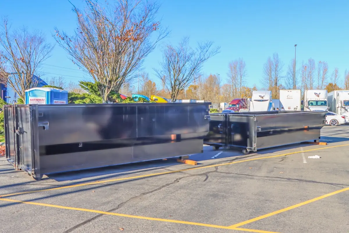 Professional dumpster rental service with roll-off container on residential driveway in Lake Forest